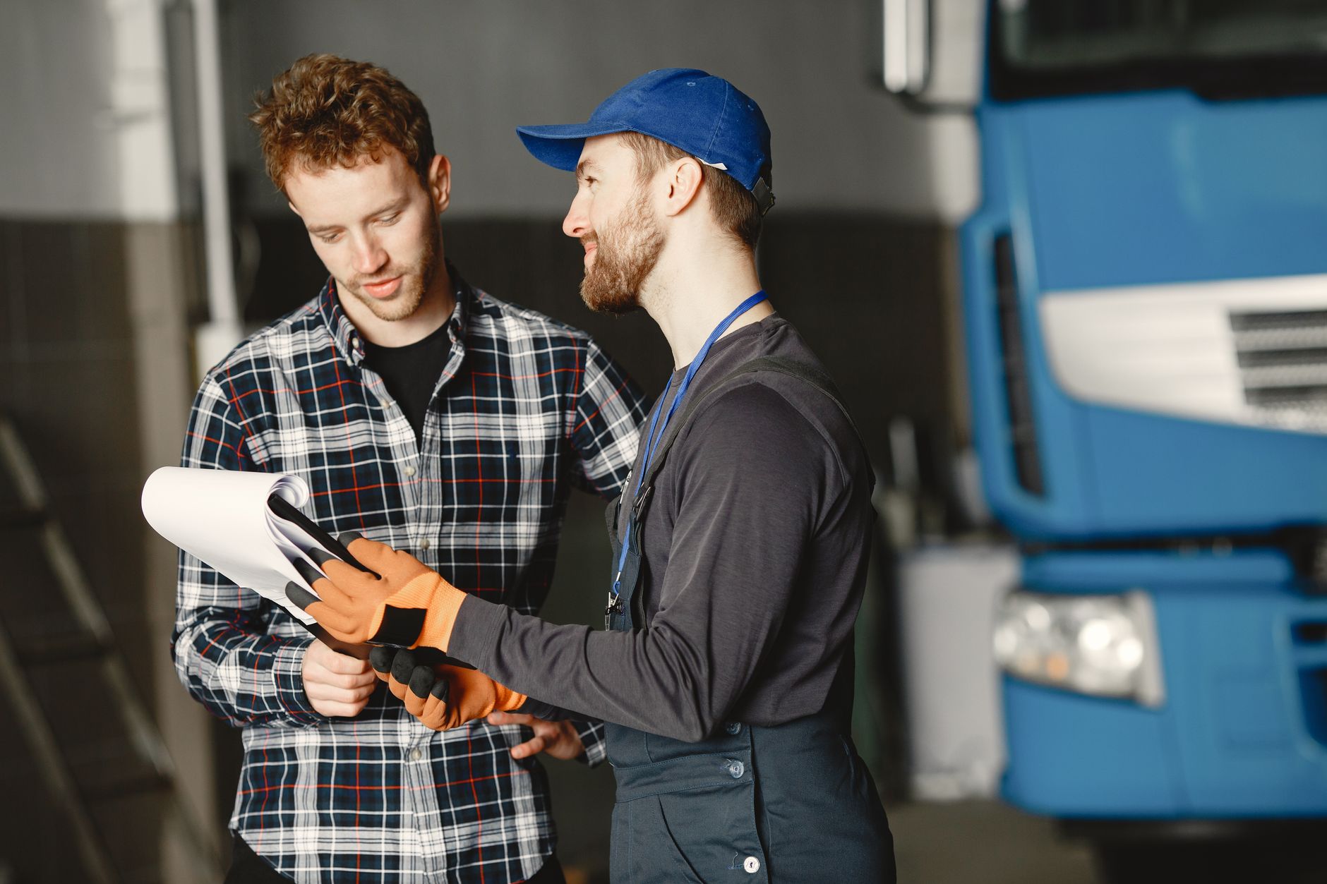 Mechanic explaining a repair to a customer in the garage